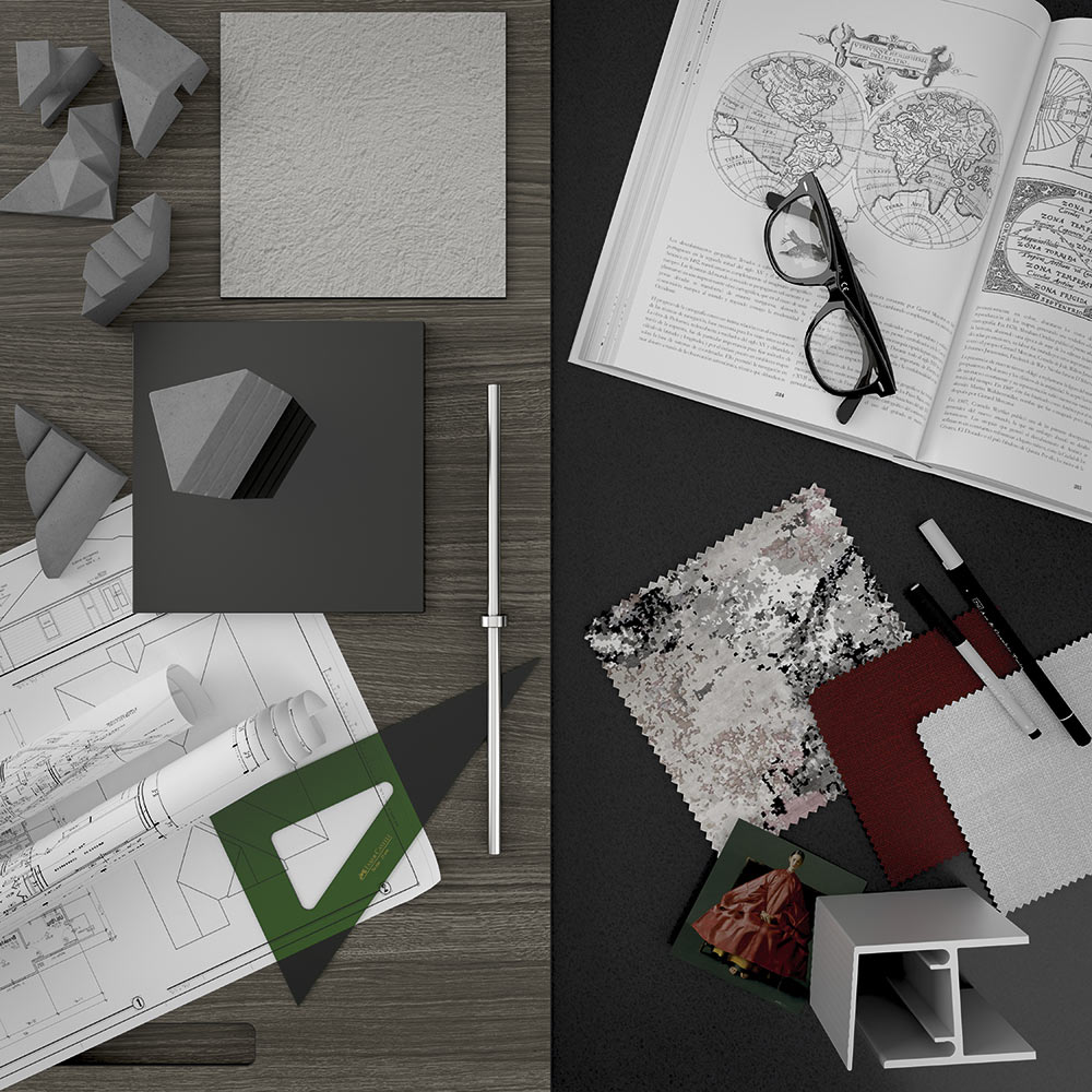 Mesa repleta de documentos de arquitectura y muestras de acabados con un libro abierto y unas gafas sobre él